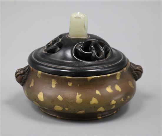 A 17th/18th century Chinese gold splashed bronze censer, Xuande mark, 19th century wood cover, jade finial H.8cm